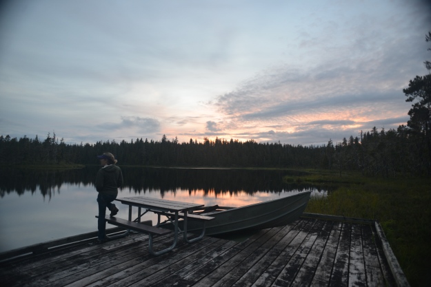 Woman on a Dock of a Lake in Alaska at Sunset